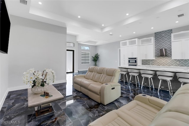 living room with a raised ceiling