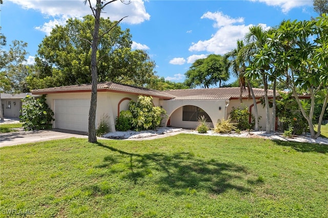 view of front of property with a garage and a front lawn