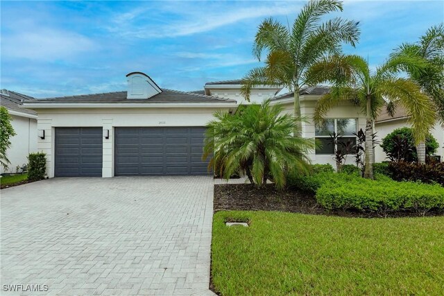 view of front facade with a front lawn and a garage