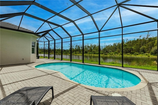 view of swimming pool with a lanai, a patio, and a water view