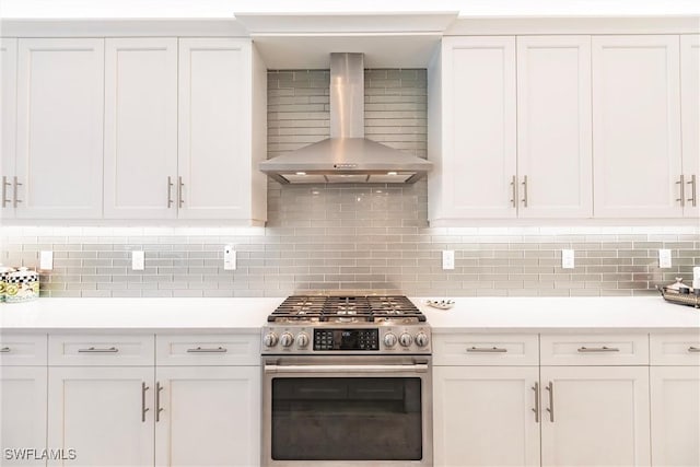 kitchen featuring white cabinetry, wall chimney range hood, stainless steel range, and tasteful backsplash