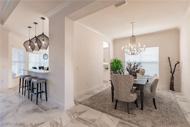 dining room with an inviting chandelier and ornamental molding