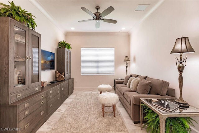 living room with ceiling fan and ornamental molding