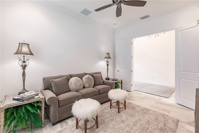 tiled living room with ceiling fan and ornamental molding