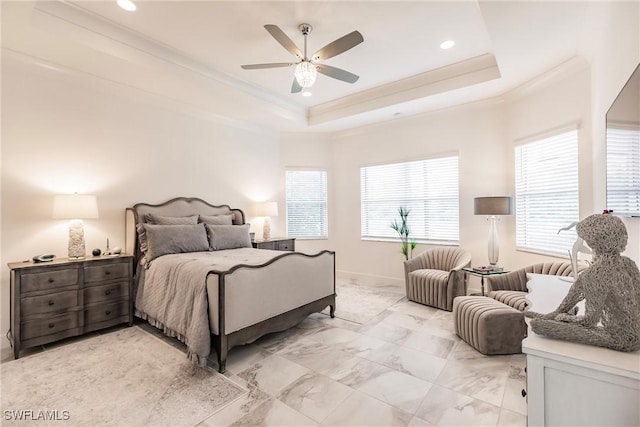 bedroom featuring ceiling fan, crown molding, and a tray ceiling