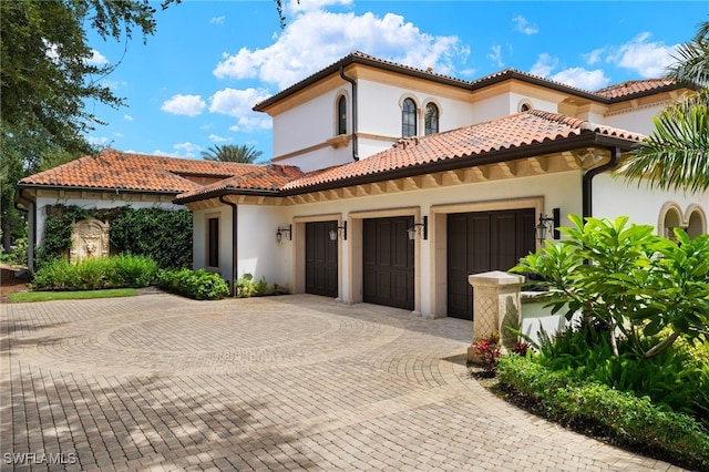 mediterranean / spanish-style home with a garage