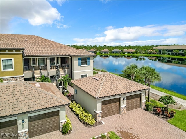 exterior space with a garage and a water view