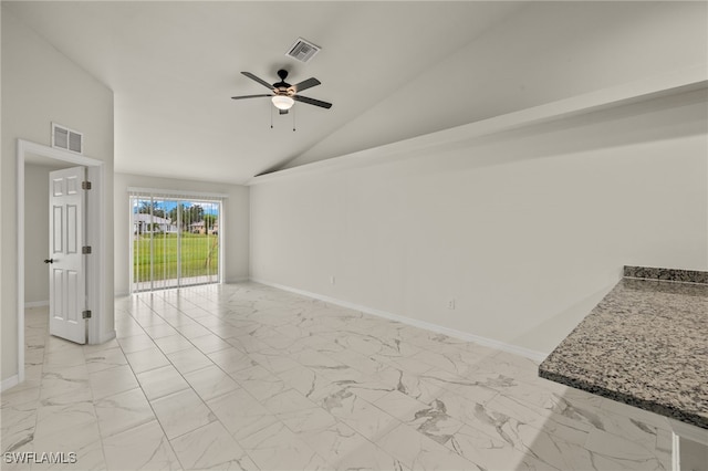 spare room featuring lofted ceiling, marble finish floor, baseboards, and visible vents