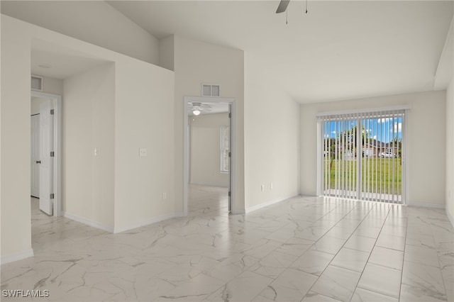 empty room featuring marble finish floor, ceiling fan, visible vents, and baseboards