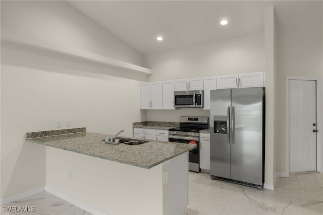 kitchen featuring high vaulted ceiling, white cabinetry, kitchen peninsula, sink, and appliances with stainless steel finishes