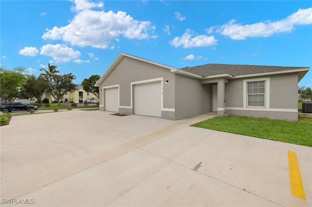 single story home featuring driveway, stucco siding, an attached garage, central air condition unit, and a front yard