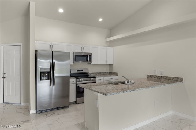 kitchen with stainless steel appliances, sink, kitchen peninsula, and white cabinets