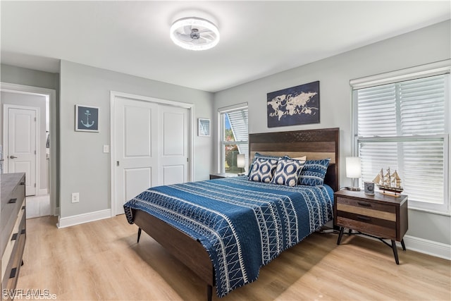 bedroom featuring light hardwood / wood-style floors and a closet