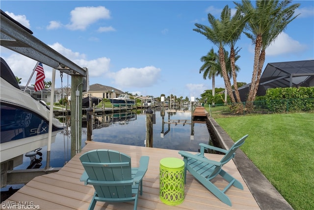 dock area with a water view and a yard