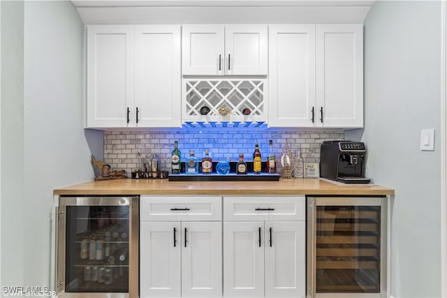 bar featuring white cabinetry, beverage cooler, and butcher block countertops