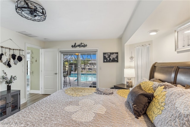 bedroom featuring dark hardwood / wood-style flooring and access to outside