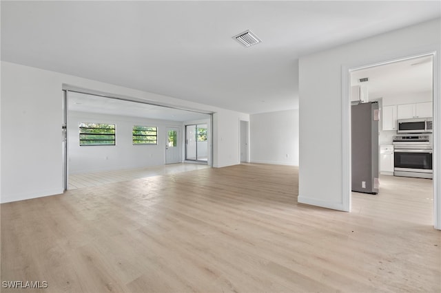 unfurnished living room with light hardwood / wood-style floors