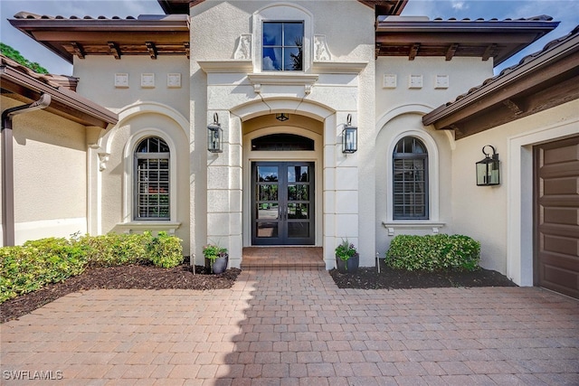 property entrance featuring french doors and a garage