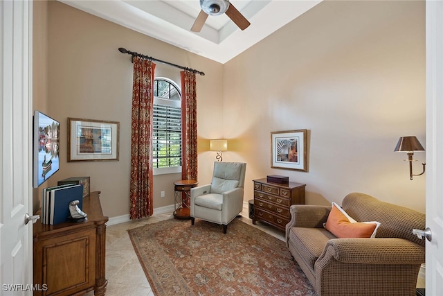 sitting room with light tile patterned floors, ceiling fan, and high vaulted ceiling