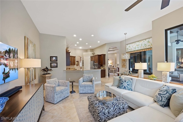 tiled living room featuring ceiling fan