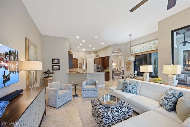 7721 Classics Dr, Naples, FL 34113 - living room featuring light tile patterned floors, recessed lighting, arched walkways, and ceiling fan