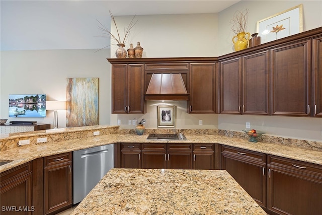 kitchen with light stone counters, appliances with stainless steel finishes, dark brown cabinetry, and premium range hood