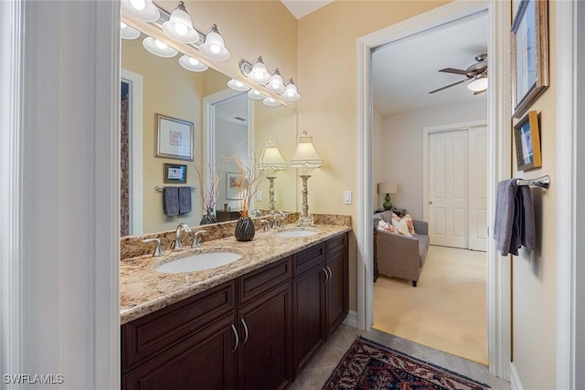 7721 Classics Dr, Naples, FL 34113 - bathroom with double vanity, a sink, tile patterned flooring, and a ceiling fan