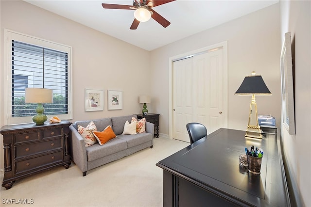 carpeted office featuring ceiling fan