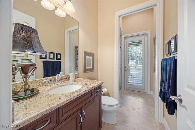 bathroom with tile patterned flooring, vanity, and toilet