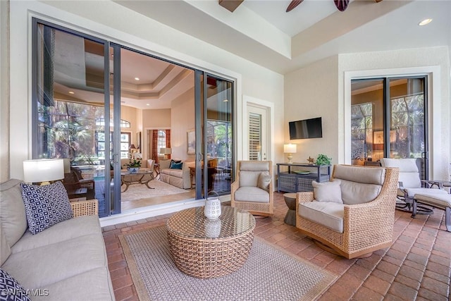7721 Classics Dr, Naples, FL 34113 - living area with french doors, plenty of natural light, a tray ceiling, and ceiling fan