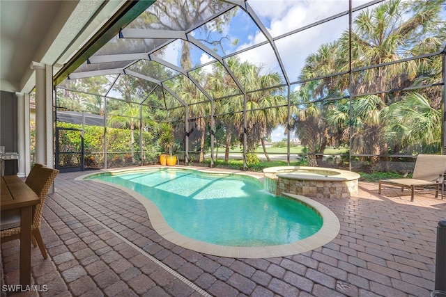 view of swimming pool with glass enclosure, an in ground hot tub, and a patio area