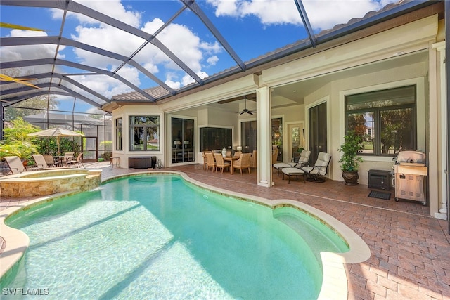 view of pool with glass enclosure, an in ground hot tub, ceiling fan, and a patio area