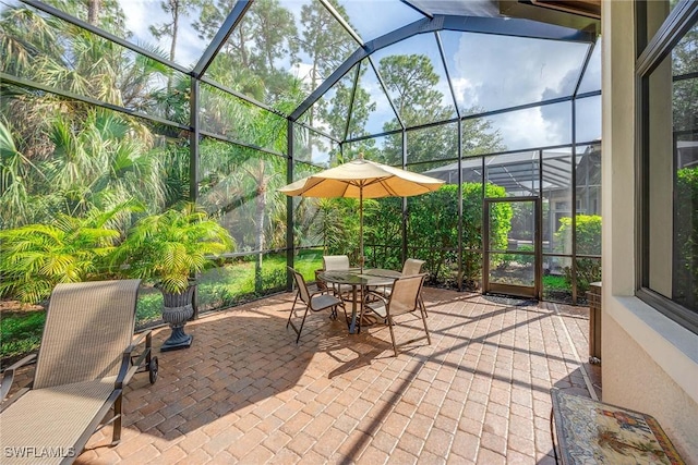 7721 Classics Dr, Naples, FL 34113 - view of patio / terrace featuring a lanai and outdoor dining space