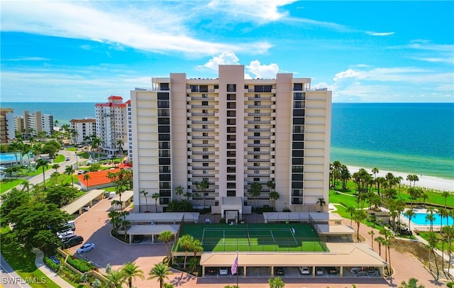 view of building exterior featuring a view of the beach and a water view