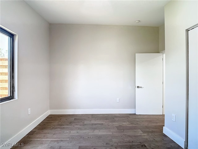 unfurnished room with wood finished floors and baseboards