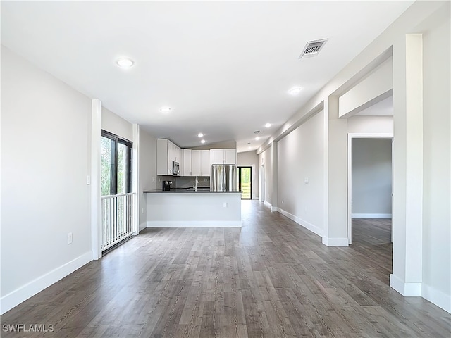 unfurnished living room featuring dark hardwood / wood-style floors