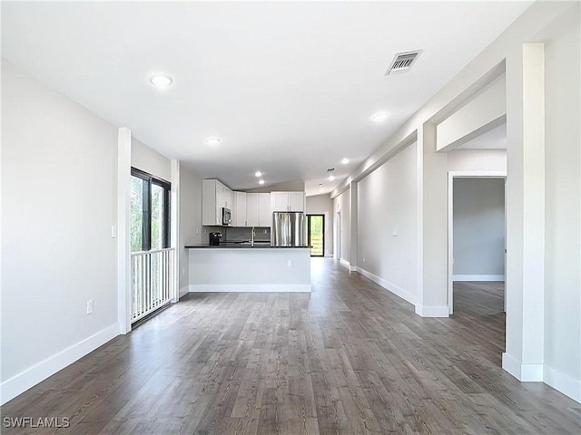 unfurnished living room featuring visible vents, recessed lighting, dark wood-type flooring, and baseboards