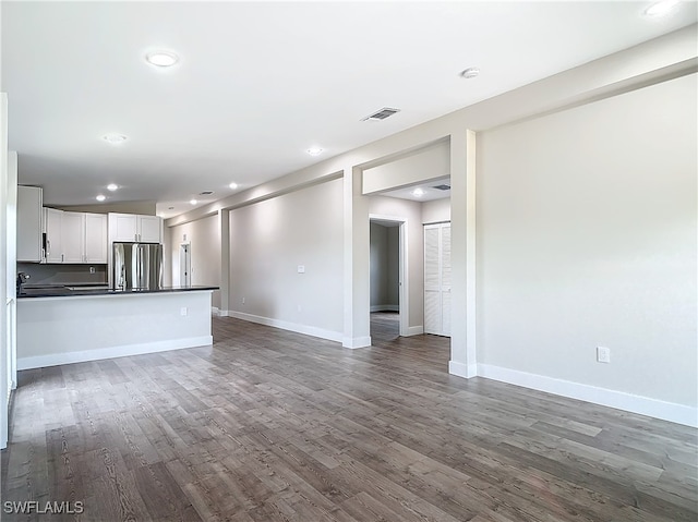 unfurnished living room featuring dark hardwood / wood-style flooring