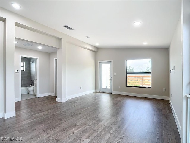 unfurnished room with recessed lighting, baseboards, visible vents, and dark wood-style flooring