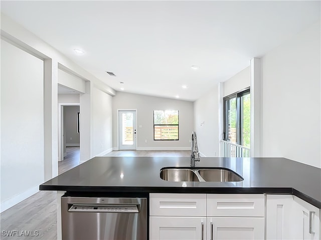 kitchen with dishwasher, light wood-type flooring, white cabinetry, sink, and lofted ceiling