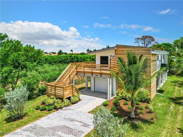 view of front of home with a wooden deck and a garage