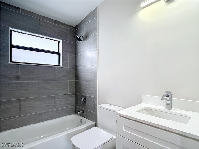 full bathroom with vanity, toilet, and tiled shower / bath combo