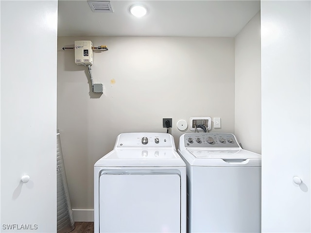 laundry area with hardwood / wood-style flooring and washer and clothes dryer