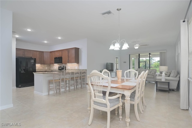 dining space featuring an inviting chandelier and light tile patterned flooring