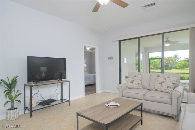 tiled living room featuring ceiling fan