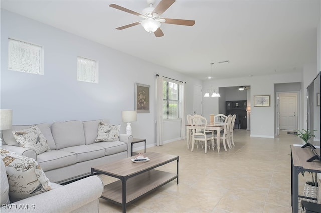 tiled living room featuring ceiling fan