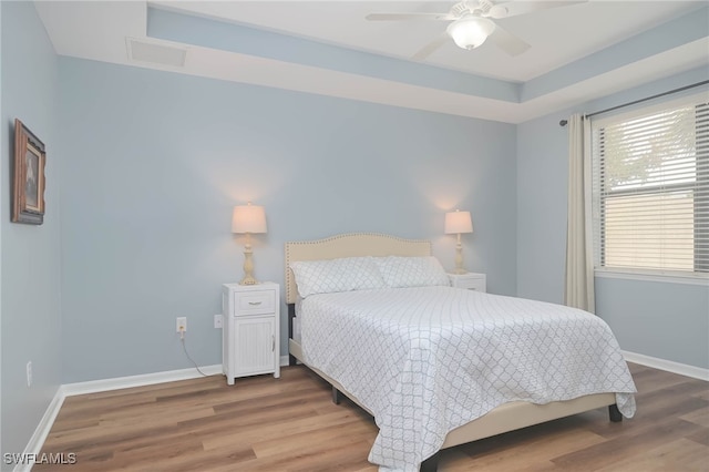 bedroom with ceiling fan and hardwood / wood-style flooring