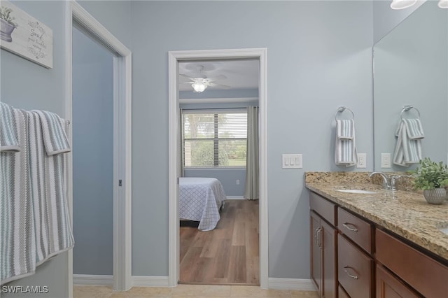 bathroom with vanity, hardwood / wood-style flooring, and ceiling fan