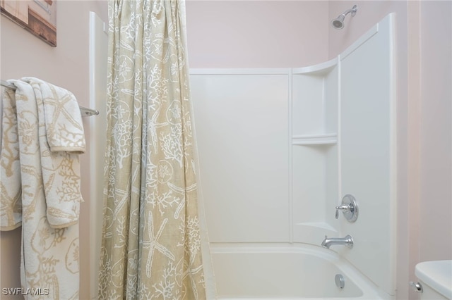 bathroom with toilet and shower / tub combo with curtain