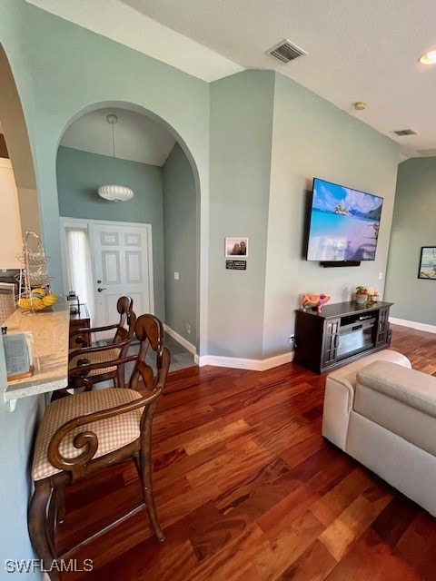 living room with dark hardwood / wood-style flooring